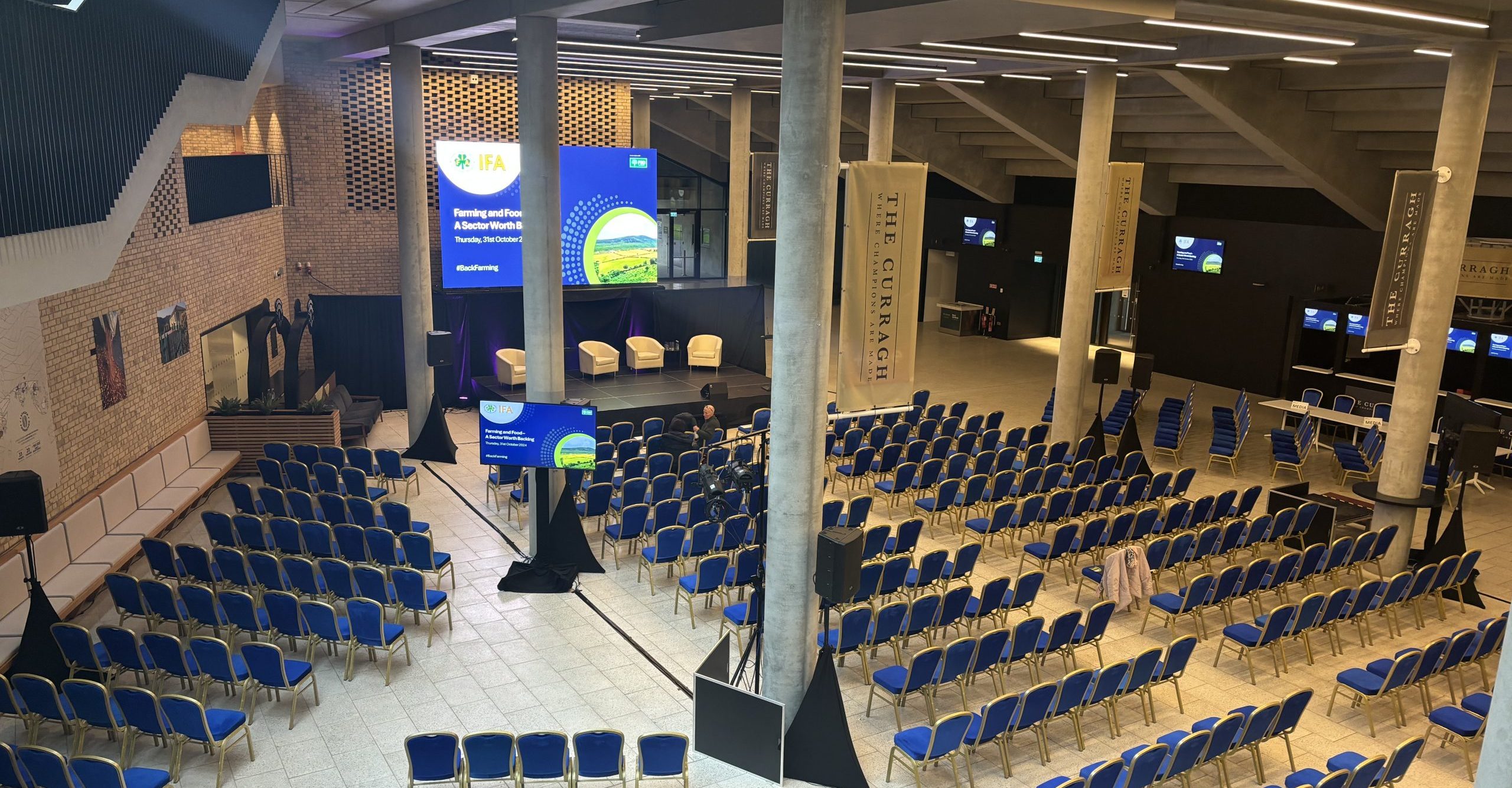 Champions Hall at the Curragh Racecourse, Ireland set up for a large conference including staging and screens